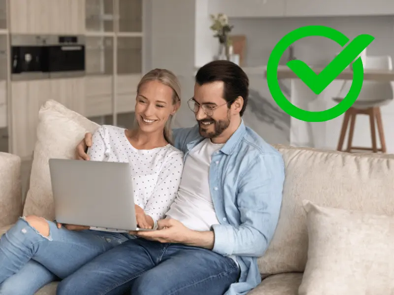 Homeowners smiling after improving credit and getting approved for a HELOC.